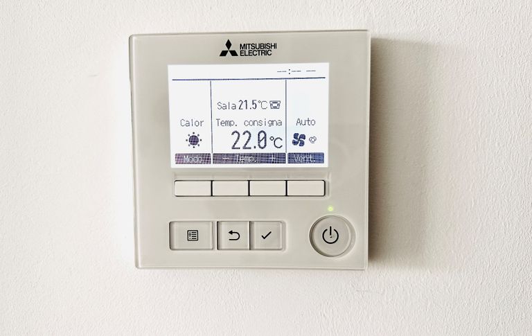 Digital thermostat displaying temperature settings